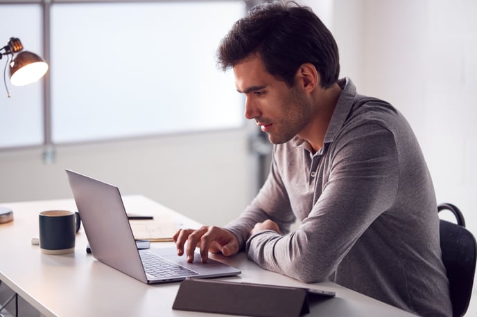 businessman-working-on-laptop-at-desk-in-modern-of-2024-10-19-06-13-45-utc-jpg-1
